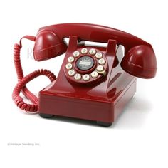 an old - fashioned red telephone is shown on a white background