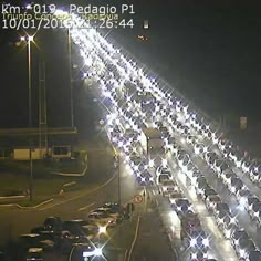 a long line of cars driving down a highway at night