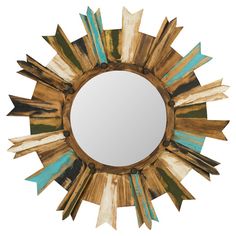 a mirror that is sitting on top of a wooden table next to a white wall