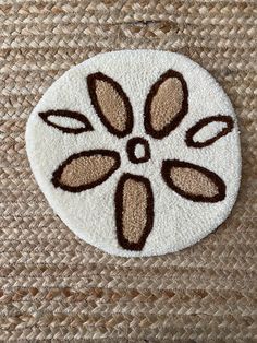 a close up of a piece of cloth with a flower design on the front and side