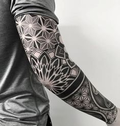 a man's arm with an intricate tattoo design on the left side of his arm