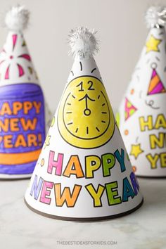 three party hats with the words happy new year written on them