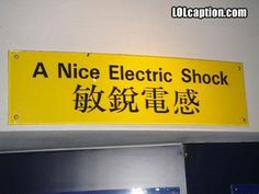 a nice electric shock sign posted on the wall in an office building with chinese writing