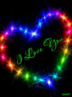 i love you written in the middle of a heart made out of colorful lights on a black background