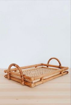 a bamboo tray with handles on a wooden table