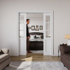 a person walking into a bedroom through an open door