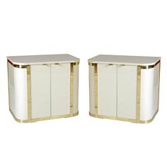 a pair of white and gold sideboards with red trim on the top one has a black stripe at the bottom