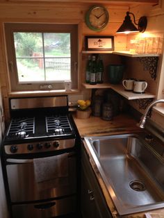 small kitchen with stainless steel stove and sink