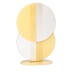 two plates sitting on top of each other in front of a white background with yellow stripes