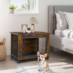 a corgi dog sitting in front of a small wooden crate on the floor