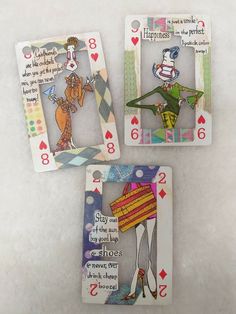 three playing cards with cartoon characters on them