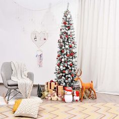 a living room with a christmas tree and presents on the floor in front of it