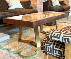 a living room with couches, chairs and a coffee table in the middle of it