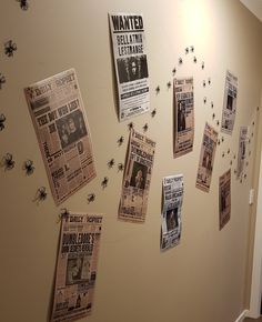 the wall is covered with newspapers and spider webs