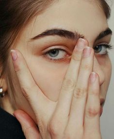 a woman covering her face with both hands