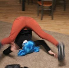 a woman laying on the floor with her legs spread out in front of her face