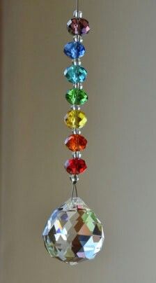 a multicolored crystal sun catcher hanging from a ceiling