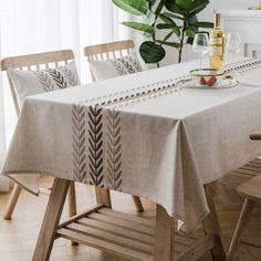 a dining room table covered with a white table cloth