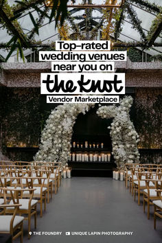 a wedding venue with rows of chairs and white flowers on the aisle, surrounded by greenery