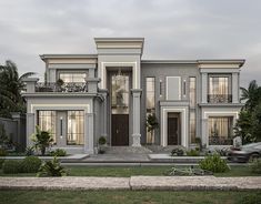 a two story house with lots of windows and balconies on the second floor