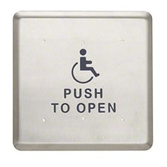 a sign that says push to open on the side of a white wall with an image of a person in a wheelchair