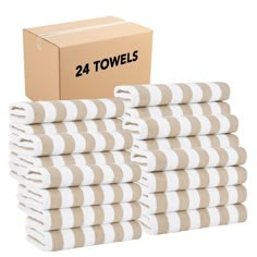 the 24 towels are stacked on top of each other in front of a cardboard box