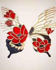 two red and black butterfly wings with flowers on it's wings, one is facing the opposite direction