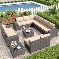 an outdoor furniture set on a deck next to a pool