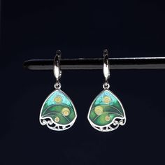 100% handmade sterling silver earrings, covered with hot cloisonné enamel. Cloisonné  is an ancient technique for decorating metalwork objects with colored material held in place or separated by metal strips or wire, normally of gold or silver. This process is quite laborious, because all the details require hand processing. Georgian cloisonné enamel counts more than 1200 years of history.  Our handmade pendants, earrings, brooches are vibrant with colour and compliment any outfit, prefered for daily wear or a special occasion. Materials: Sterling Silver, Fine Silver, Cloisonne enamel Weight - 6 gr (approx) Drop Lenght - 2.2 cm; 0.9 inches  Lenght - 3.5 cm; 1.4 inches Width - 1.8 cm; 0.7 inches  Matching Pendant: https://www.etsy.com/listing/1311367379/georgian-cloisonne-enamel-pendant?cli Elegant Enamel Dangle Earrings, Enamel Ear Wire Jewelry, Pierced Enamel Drop Earrings, Single Green Enamel Earring, Green Enamel Single Earring, Green Teardrop Clip-on Earrings, Enamel Teardrop Jewelry With Matching Earrings, Enamel Drop Earrings With Ear Wire, Pierced Dangle Earrings In Enamel