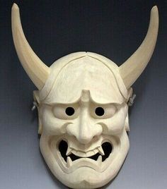 a white mask with large horns and eyes