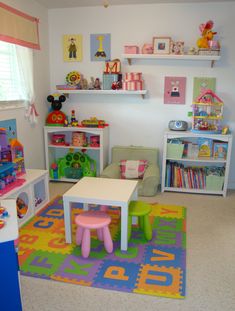 a child's playroom with toys, bookshelves and desks in it