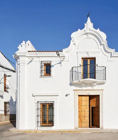 a white building with wooden doors and windows