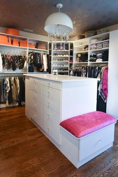 a closet with white drawers and shelves filled with clothes