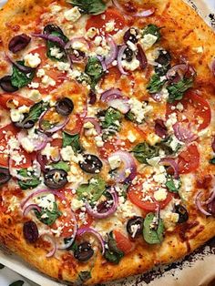 a pizza sitting on top of a pan covered in toppings