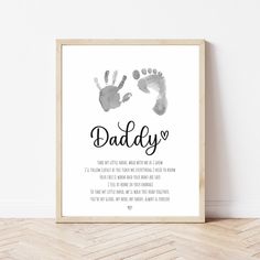 a framed print with the words daddy and two hand prints