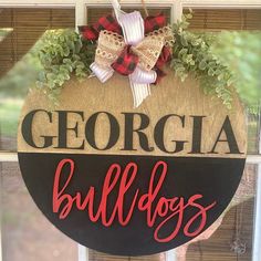 a sign that says georgia bulldogs hanging on the side of a window