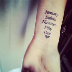 a person with a tattoo on their wrist that says january eight nine nineteen fifty one