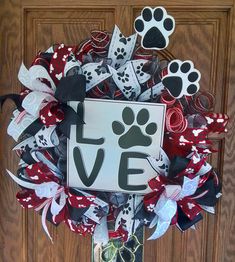 the front door is decorated with red, white and black wreaths that say love