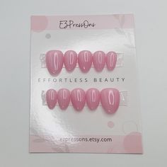 Introducing this set of extra short, almond press on nails, meticulously hand painted with gel nail polish. These nails are classified as extra short by the manufacturer but may be considered extra short or short length depending on the length of your nail bed.  COLOR: Pink NAIL SHAPE SHOWN IN PHOTOS: Extra Short Almond Nails (Una Gella) With your purchase, you will receive an application kit comprising a cuticle pusher, buffing block, alcohol prep pads, and a convenient bottle of nail glue. If Press On Pink Nails, Extra Short Almond Nails, Almond Press On Nails, Bed Color, Short Almond Nails, Short Almond, Nail Bed, Pink Nail, Cuticle Pusher