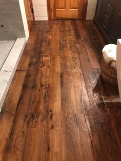 a wooden floor in a bathroom next to a sink