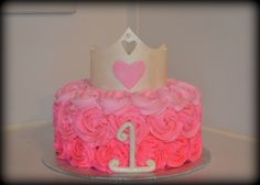 a birthday cake with pink roses and a princess crown on top is shown in this image