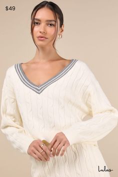 The Lulus Studious Charm Ivory and Heather Grey Cable Knit Varsity Sweater is the cutest way to ace any trendy look this season! Soft and stretchy cable knit shapes this sweater top with a classic V-neckline that boasts a heathered grey, varsity-style striped trim. Long sleeves with drop shoulders frame the relaxed, slightly cropped bodice. Ribbed knit accents the neckline, cuffs, and hem. Pair with the matching skirt for a complete look! Fit: This garment fits true to size. Length: Size medium Trendy Cable Knit V-neck Sweater, Winter Cable Knit V-neck Cropped Sweater, Chic Cable Knit V-neck Top, Luxury Cable Knit V-neck Top, Beige Cable Knit Long Sleeve V-neck Sweater, Varsity Sweater, Cable Knit, Sweater Sizes, Heather Grey