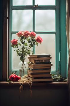 a stack of books sitting on top of a window sill next to a vase filled with roses