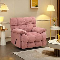 a pink recliner in a living room with two lamps on either side of it