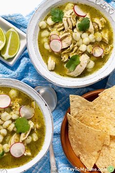 two bowls of chicken tortilla soup on a blue towel