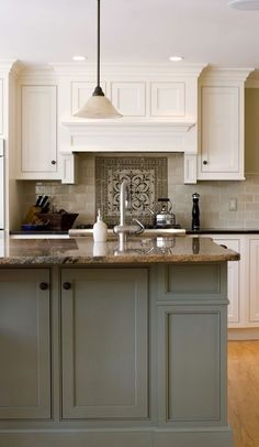 a large kitchen with white cabinets and marble counter tops, along with an island in the middle