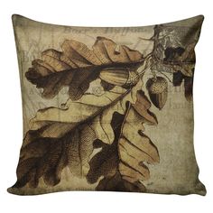 a decorative pillow with an image of a tree branch and acorns on it