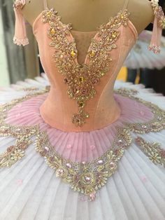 a pink ballerina dress on display in a store