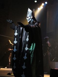 a man dressed up in a costume on stage