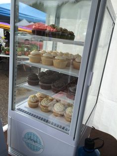 a display case filled with lots of cupcakes